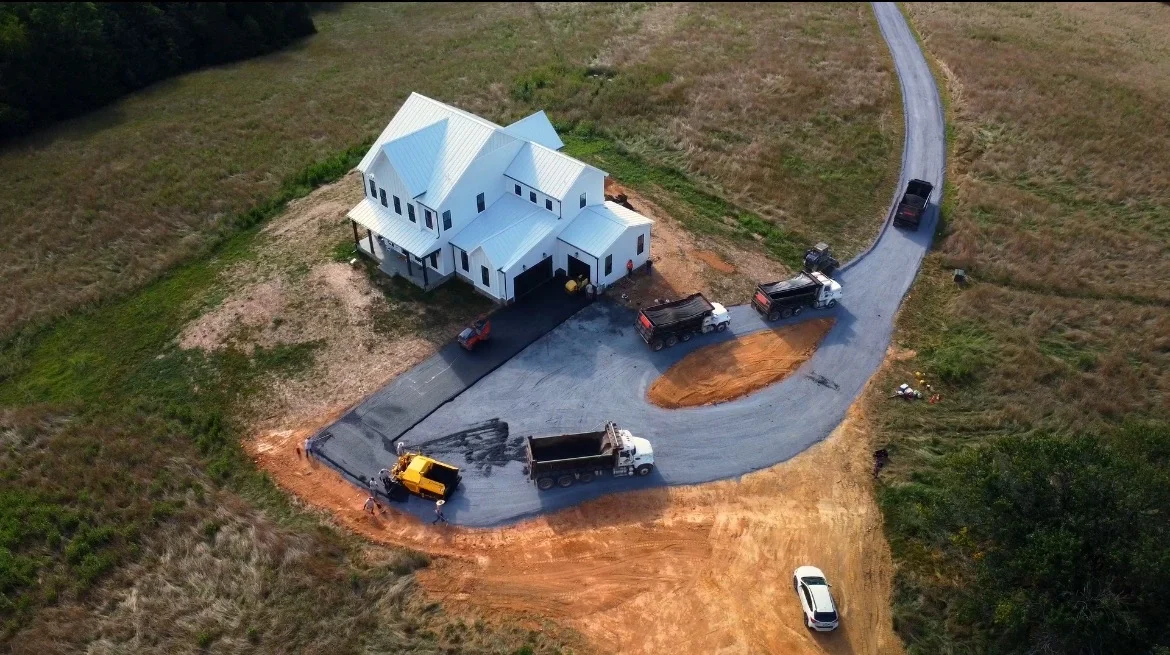 Best asphalt paving company in Prince William County, VA working with its machinery & team on a large driveway paving project