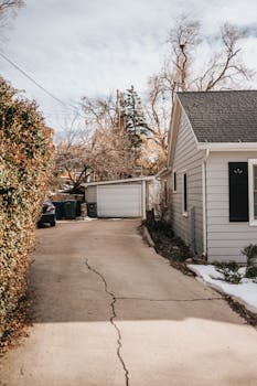 cracked driveway needing an upgrade to asphalt paving for better curb appeal