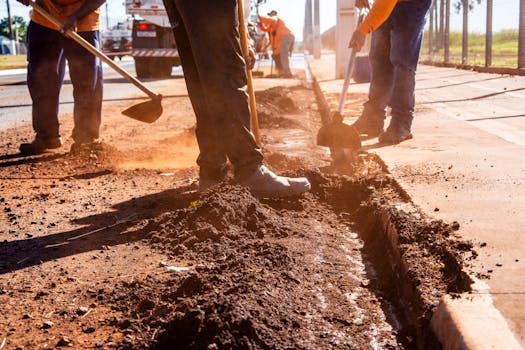 aspahlt crew working on site to improve drainage problems