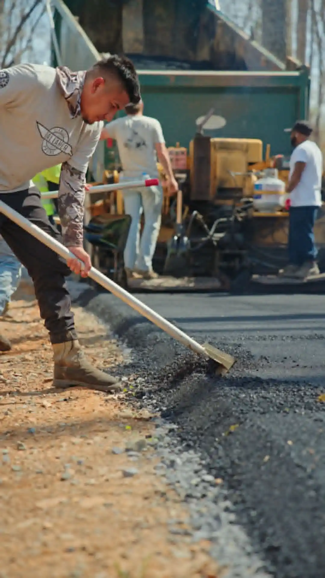 asphalt experts finishing a road paving projects