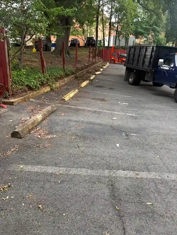 Existing parking lot with worn asphalt and parking spaces before paving in Arlington, VA